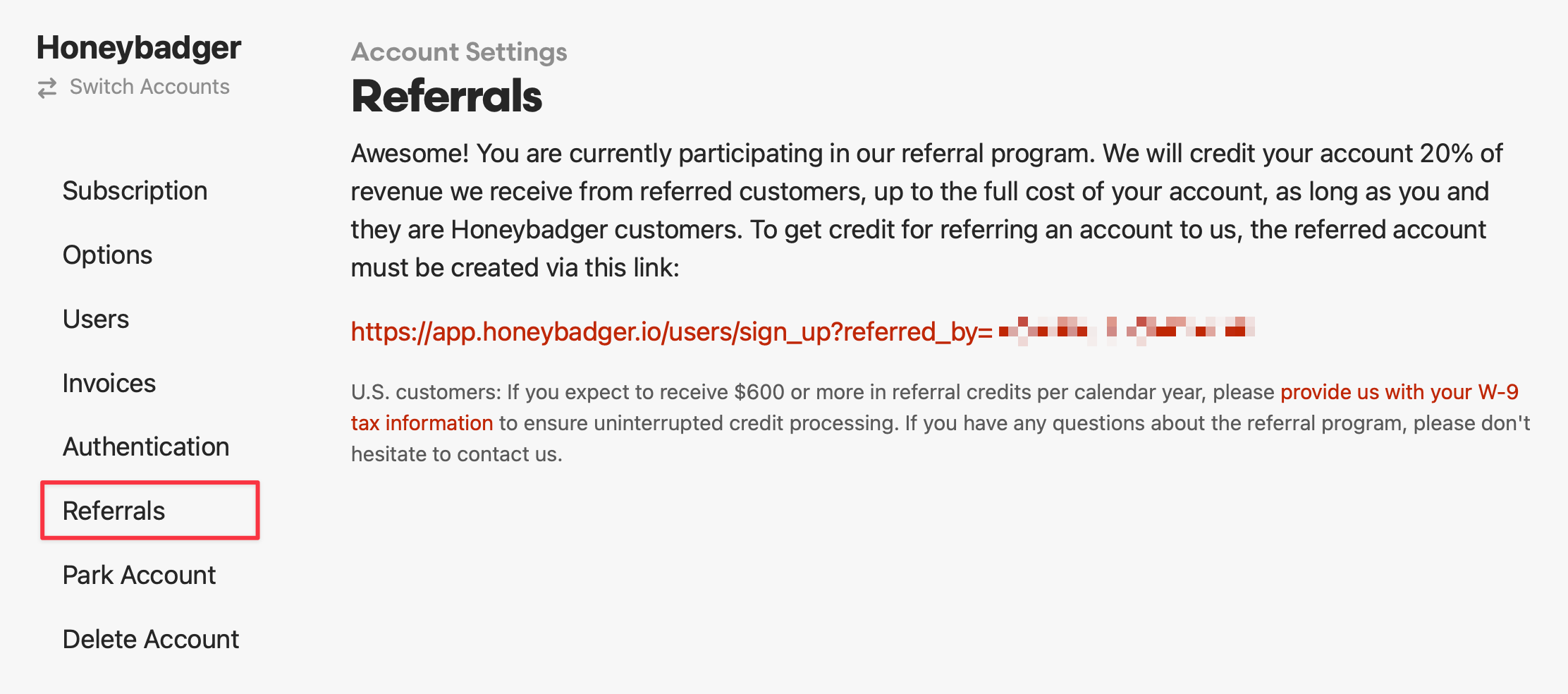 Screenshot of Honeybadger's referral program settings page showing a 20% revenue sharing program where users receive credits up to their full account cost for successful referrals. The page displays a unique referral link and includes tax information requirements for U.S. customers expecting $600+ in annual referral credits, with the 'Referrals' menu item highlighted in red.